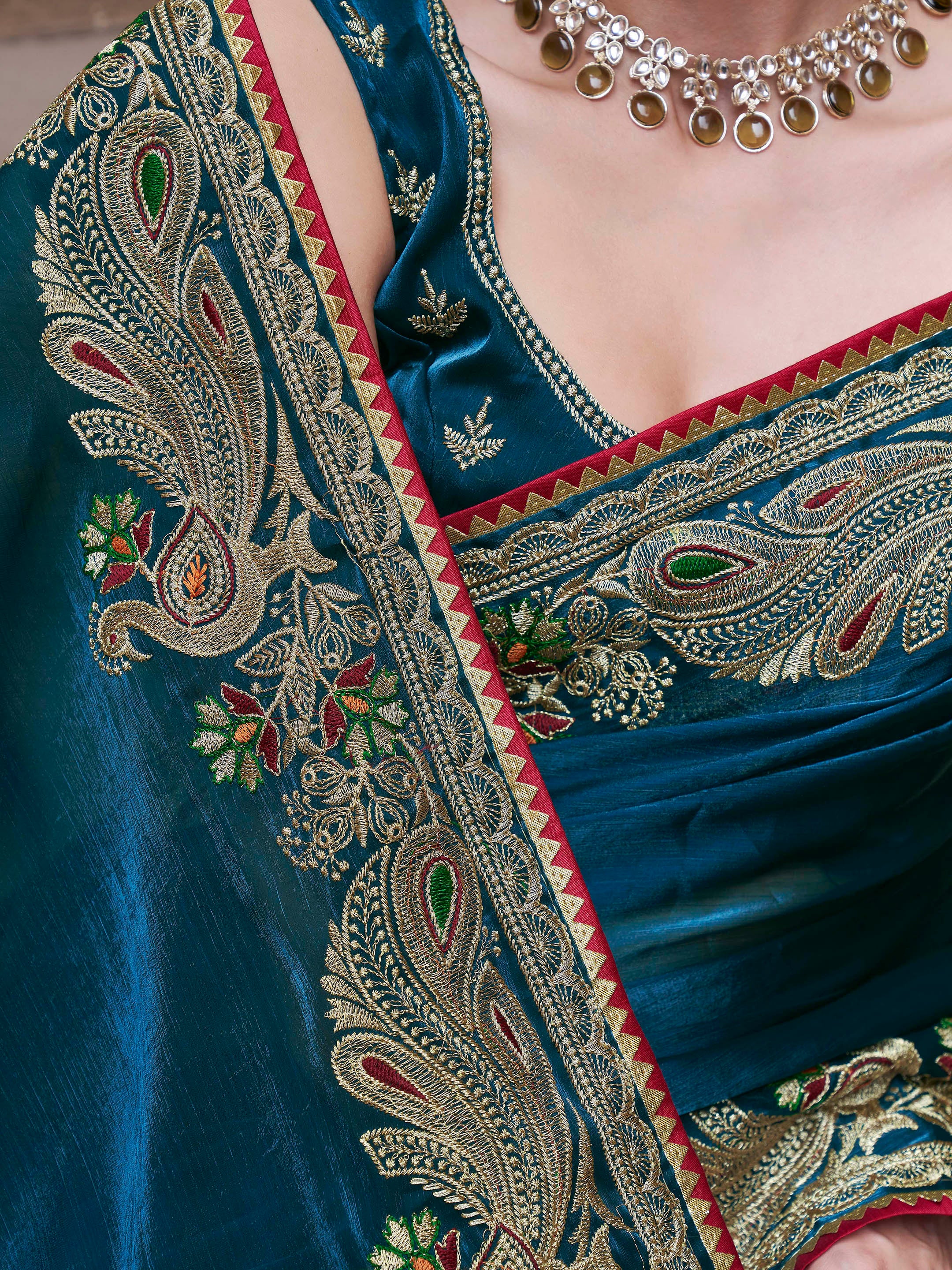 Teal colored zari embroidered saree